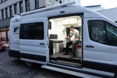 An employee of Mental Health and Addiction Association of Oregon inside an outreach van 