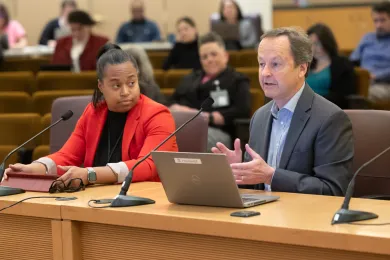 Antoinette Payne and Dan Field sit at the dais in the Multnomah County board room