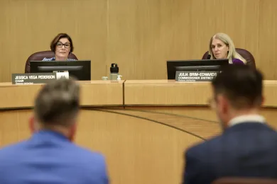 Chair Jessica Vega Pederson and Commissioner Julia Brim-Edwards sit at the dais.