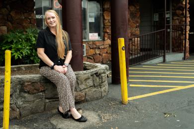 Wendie Smith sits outside a motel shelter