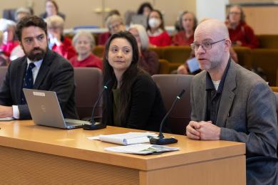 Sustainability Director John Wasiutynski, Cristina Nieves, District 1 policy advisor, and Emergency Management Director Chris Voss address the Board.