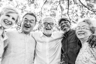 Five older adults/senior citizens pose for photo. 