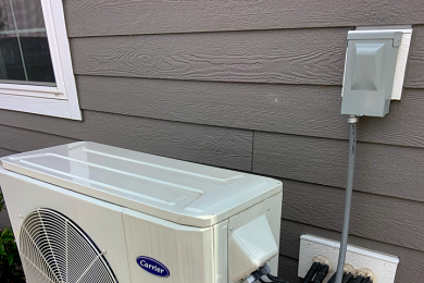 A heat pump located outside of the residential home.