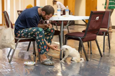 A guest and their dog enjoys respite at the cooling center at Portland Covenant Church on Monday, Aug. 11, 2025. 