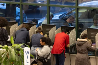voters using individual voting units inside the elections building lobby
