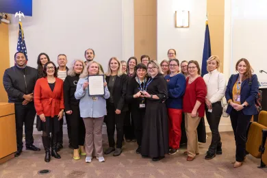 Photo with Board of County Commissioners, community members and County staff standing for photo. 