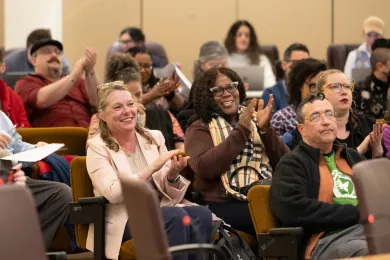 Close-up of audience members at a Multnomah County Board meeting.