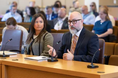 Deputy Chief Operating Officer Sara Morrissey and Homeless Services Director Nathaniel VerGow sit at the dais.