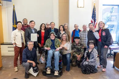 Board members, County staff and invited guests pose with the signed Vietnamese-American Remembrance Day proclamation in the boardroom.