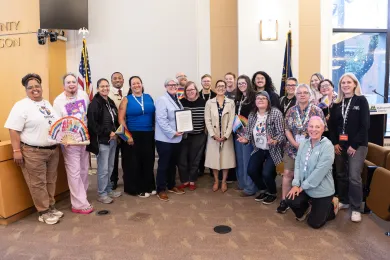Community members and County leaders gather for a photo to celebrate the singing of the Pride Month Proclamation.