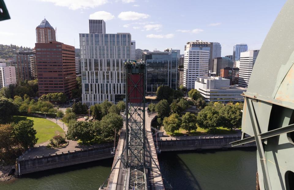 A photo from an elevated location looking down on the city skyline, with one of the Hawthorn Bridge lift towers in the foreground.