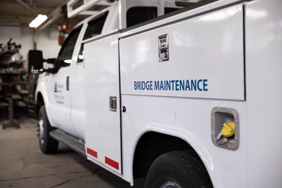 Side view of a white work truck labeled Bridge Maintenance.