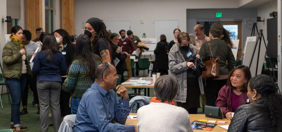 People gather at the Multnomah County Climate Justice Plan open house. Location: Holgate Library community room.