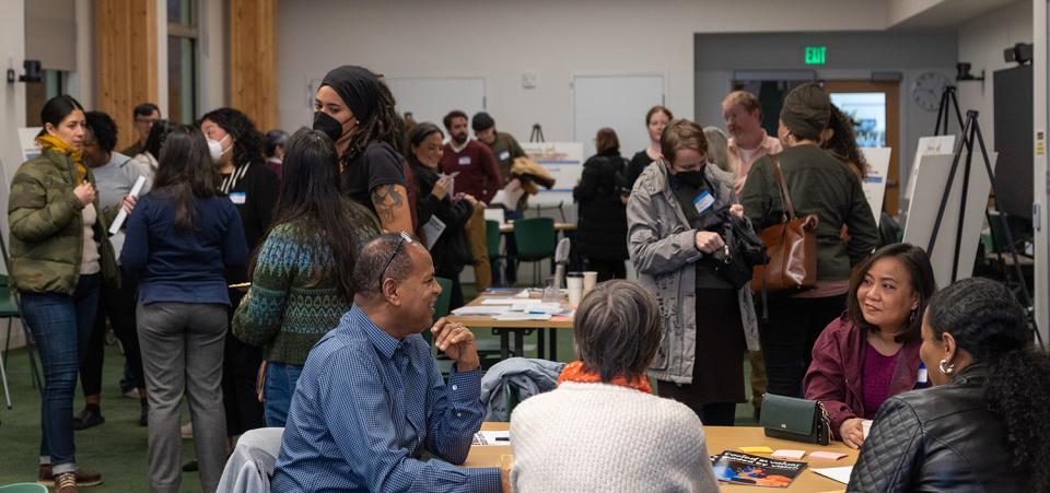 People gather at the Multnomah County Climate Justice Plan open house. Location: Holgate Library community room.