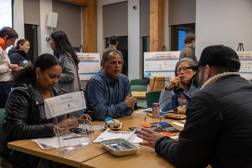 People gather at the Multnomah County Climate Justice Plan open house. Location: Holgate Library community room.