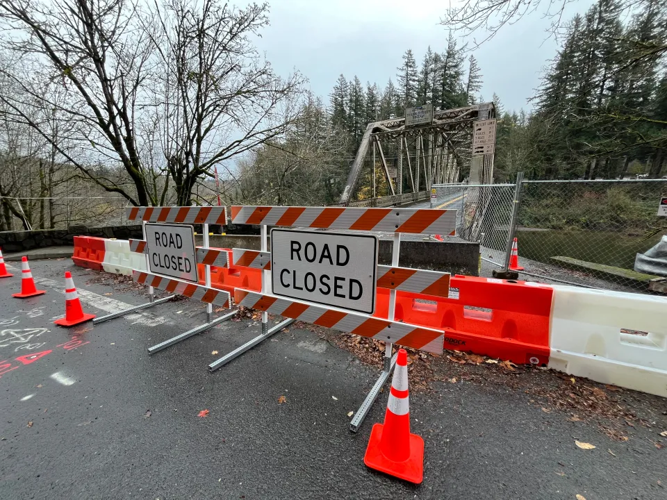 Road Closed signs and plastic barriers close off one end of the Stark Street bridge.