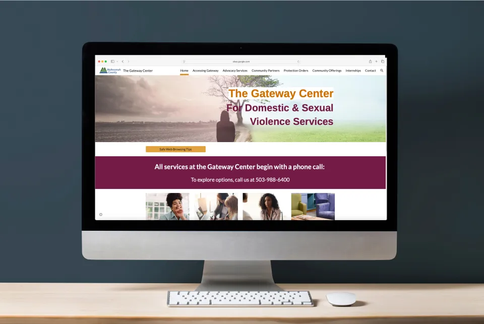 Computer displaying The Gateway Center for Domestic & Sexual Violence Services website with nature imagery. Contact number and service details are visible.