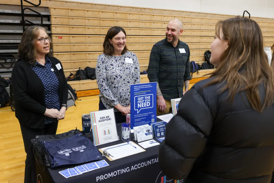 Audit staff speaking with high school students at Central Catholic tabling event