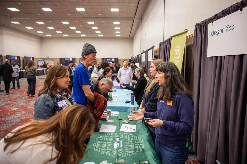 Dueños de negocios hablando con empleados del Metro en una mesa verde