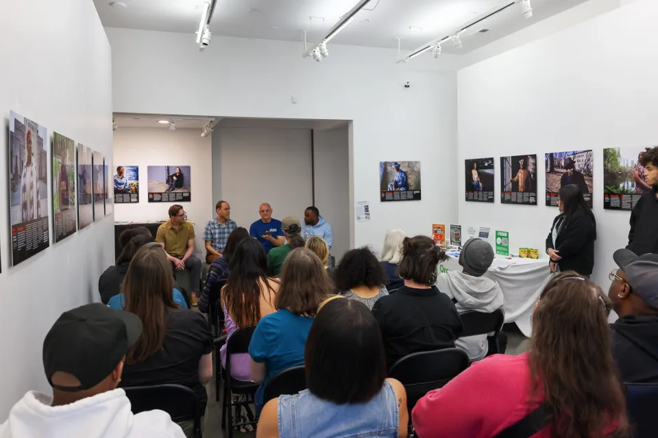 The Black gallery with people seated in chairs
