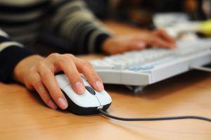 Womans hand on a computer mouse