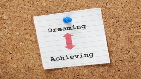 photo of bulletin board with dreaming achieving 