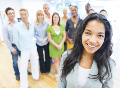 photo of beautiful young woman with colleagues