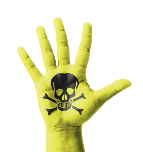 A photo of a green hand with toxic symbol on it. 