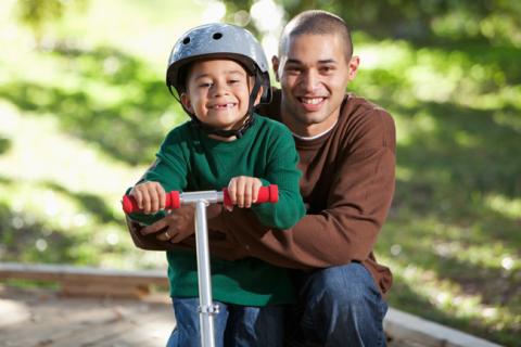 boy posing on scooter with dad