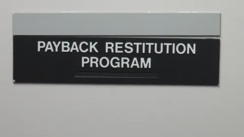 photo of sign for Project Payback restitution program