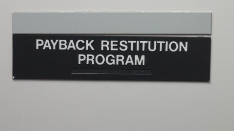 photo of sign for Project Payback restitution program