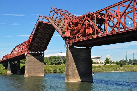 The Broadway Bridge bascule spans can open for river traffic to pass.