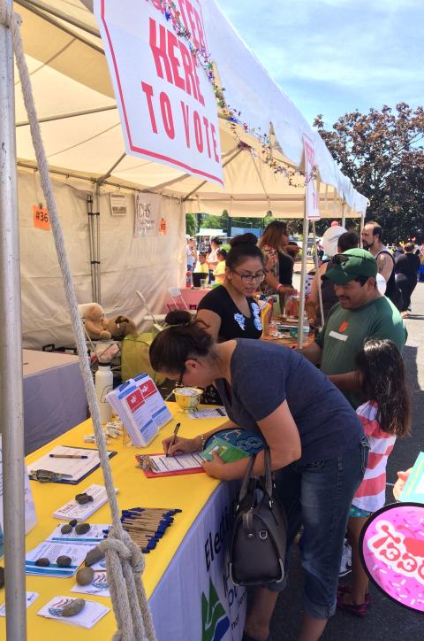 Community members registering to vote at Rock the Block 2016.