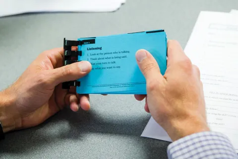 Blue note card with the word listen.