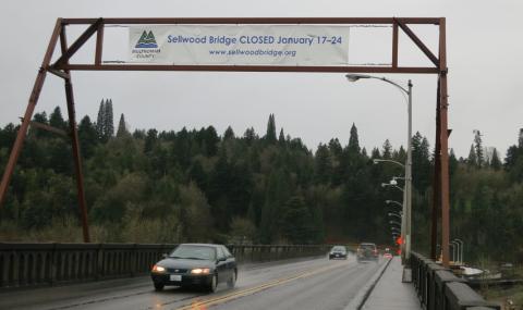 A banner hanging over the bridge reads 'Sellwood Bridge CLOSED January 17-24'.