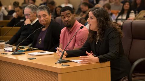 Chief Operating Officer Marissa Madrigal (right) address the board as Kory Murphy, member of the Safety, Trust and Belonging Advisory Council and equity and inclusion manager for the Department of County Assets looks on. 