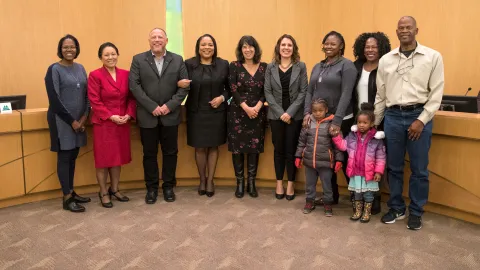Members of the Gladys McCoy Family join Board of Commissioners in adopting new hiring standard