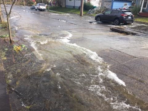 Water flows down street during water main break.