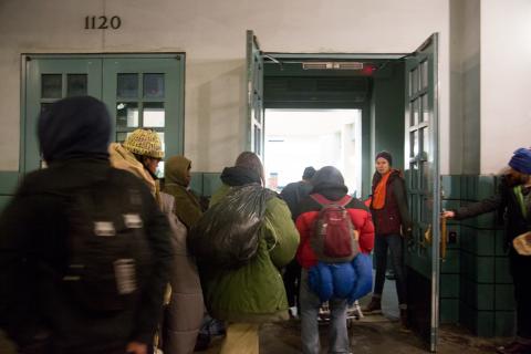 People arriving with their belongings to a warming center