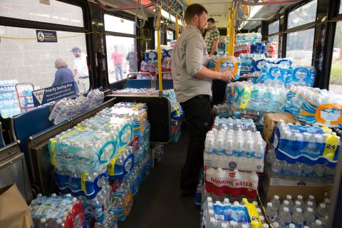 A bus filled with crates of bottled water