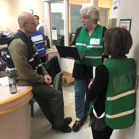 The EOC Manager and two PIOs conferring.