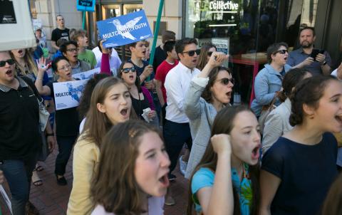 Chair Kafoury marching in a crowd with Commissioner stegman and others, people holding signs.