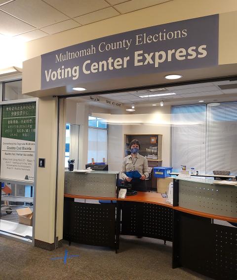 Election staff standing in front of the Voting Center Express