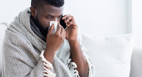 Sick African American man calling for medical help