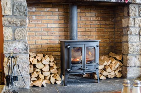 Wood stove with stacked and split fire wood