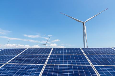 Solar panels and wind turbine create renewable electricity