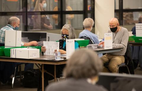 Observers watching the opening boards during the November 2020 General Election.