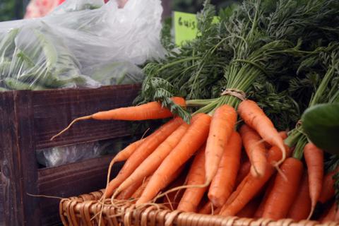 locally-grown carrots for sale at a farm stand