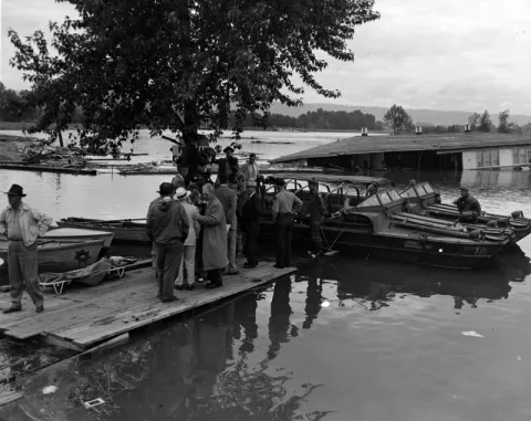 President Harry S. Truman is in Oregon inspecting flood damage. He is with a group of men who are not identified. President Truman is on his Western Trip.