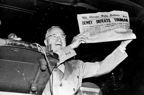 Black and white photograph of President-elect Harry S. Truman holding an early edition of the November 4, 1948 Chicago Tribune mistakenly announcing Dewey's victory.